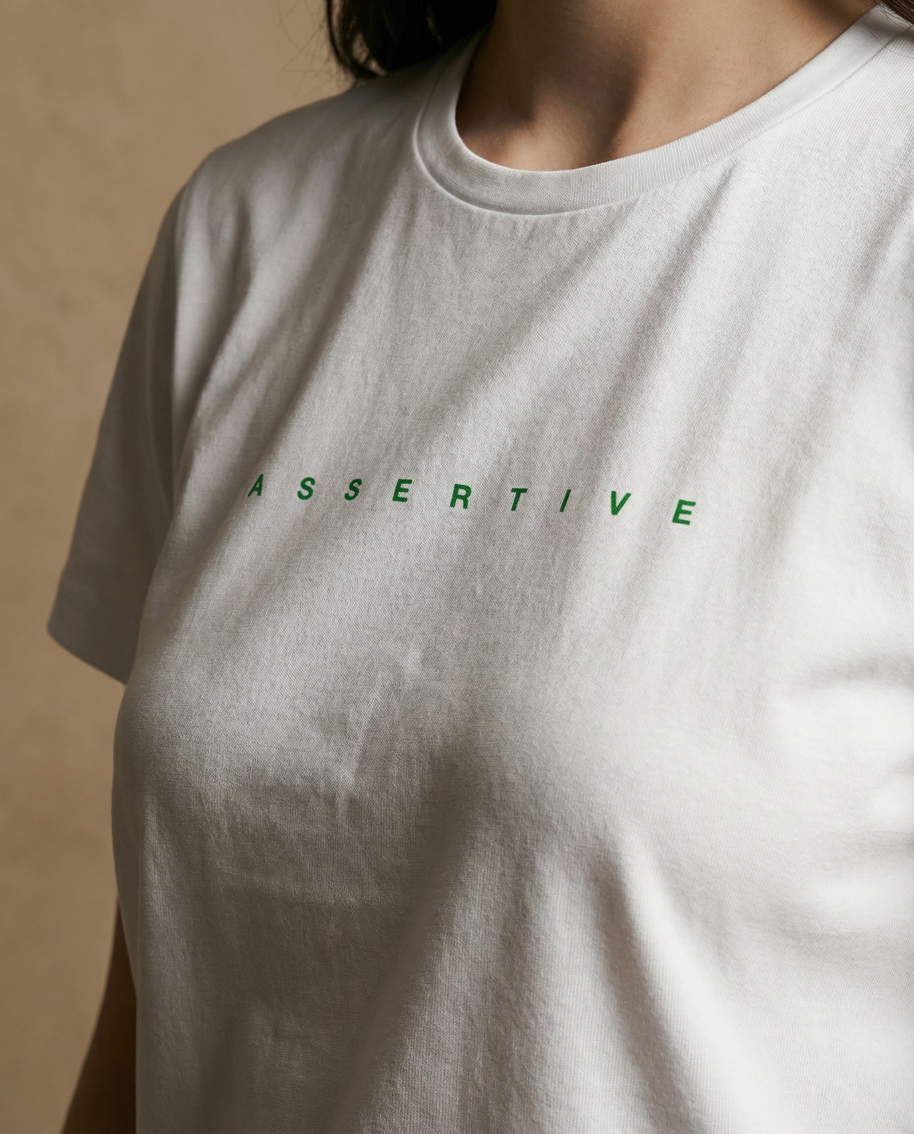 Women's Assertive Performance Crewneck by aurulu in printed material, featuring a stylish and comfortable design.
