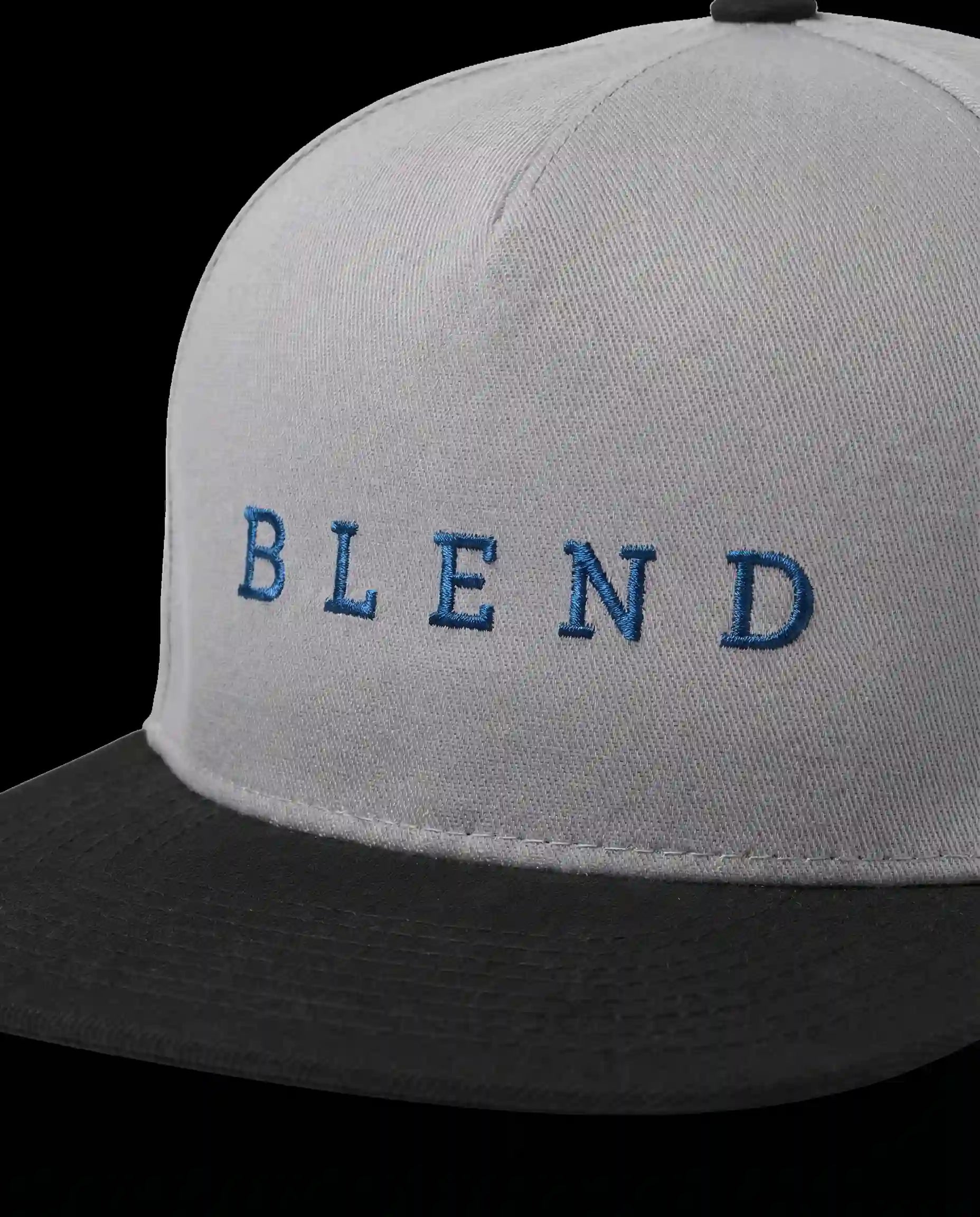 Aurulu Blend Snapback Cap with printed material, showcasing a stylish, adjustable black and white cap with graphic design.