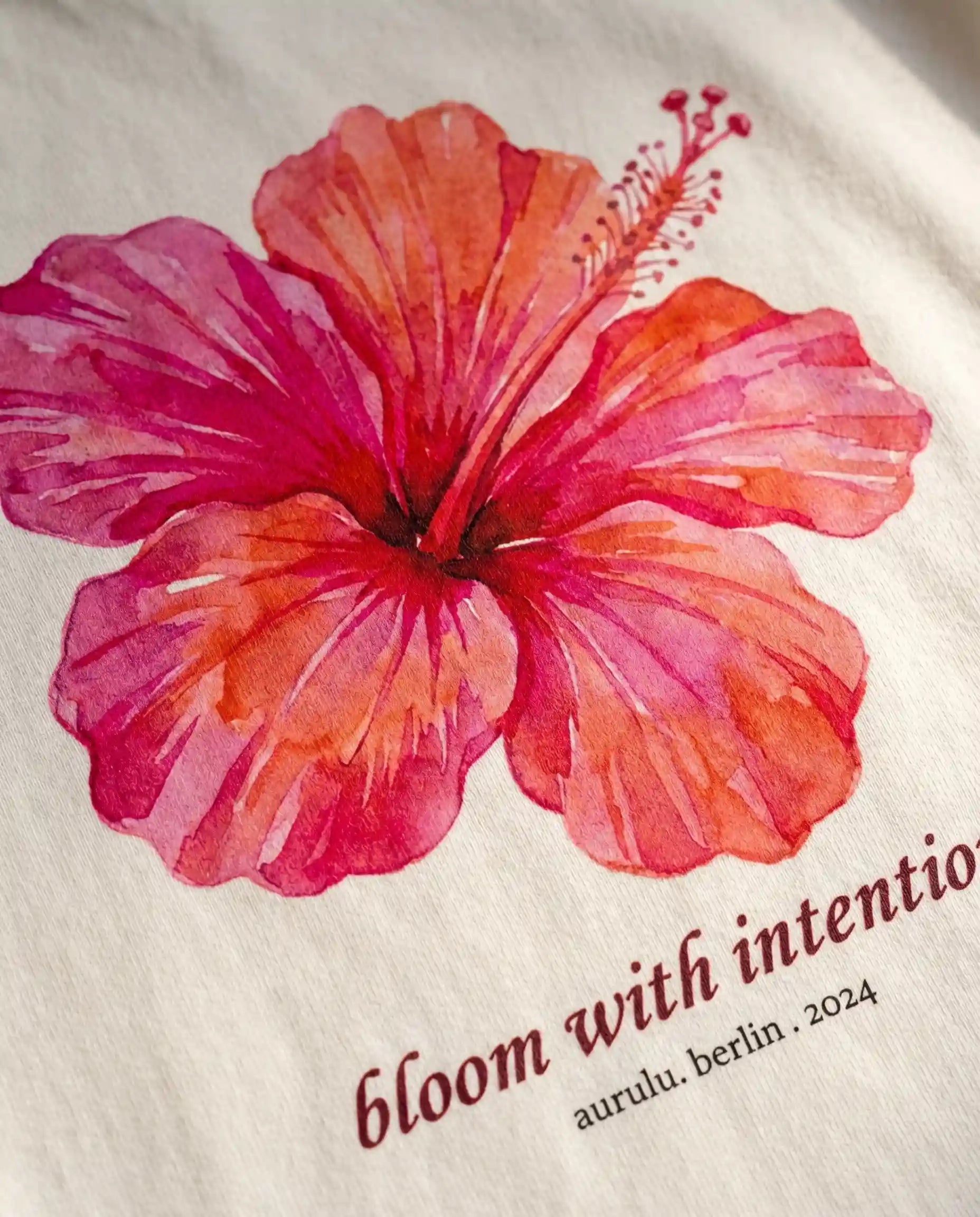 Aurulu Bloom With Intention women's oversized print tee featuring floral design on soft fabric.