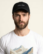 Aurulu Chill Vibes print material cap featuring a stylish design with vibrant colors and a relaxed, casual style.