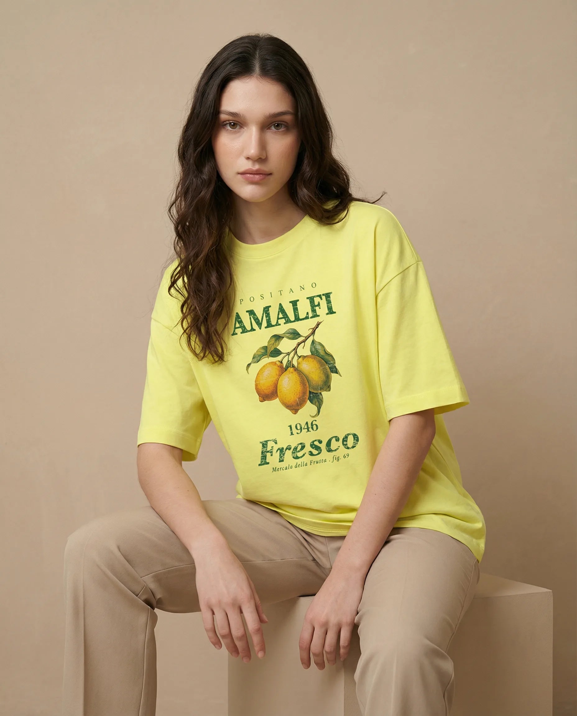 Aurulu Amalfi Fresco women's oversized print tee featuring a vibrant Positano and Amalfi coastal scene.