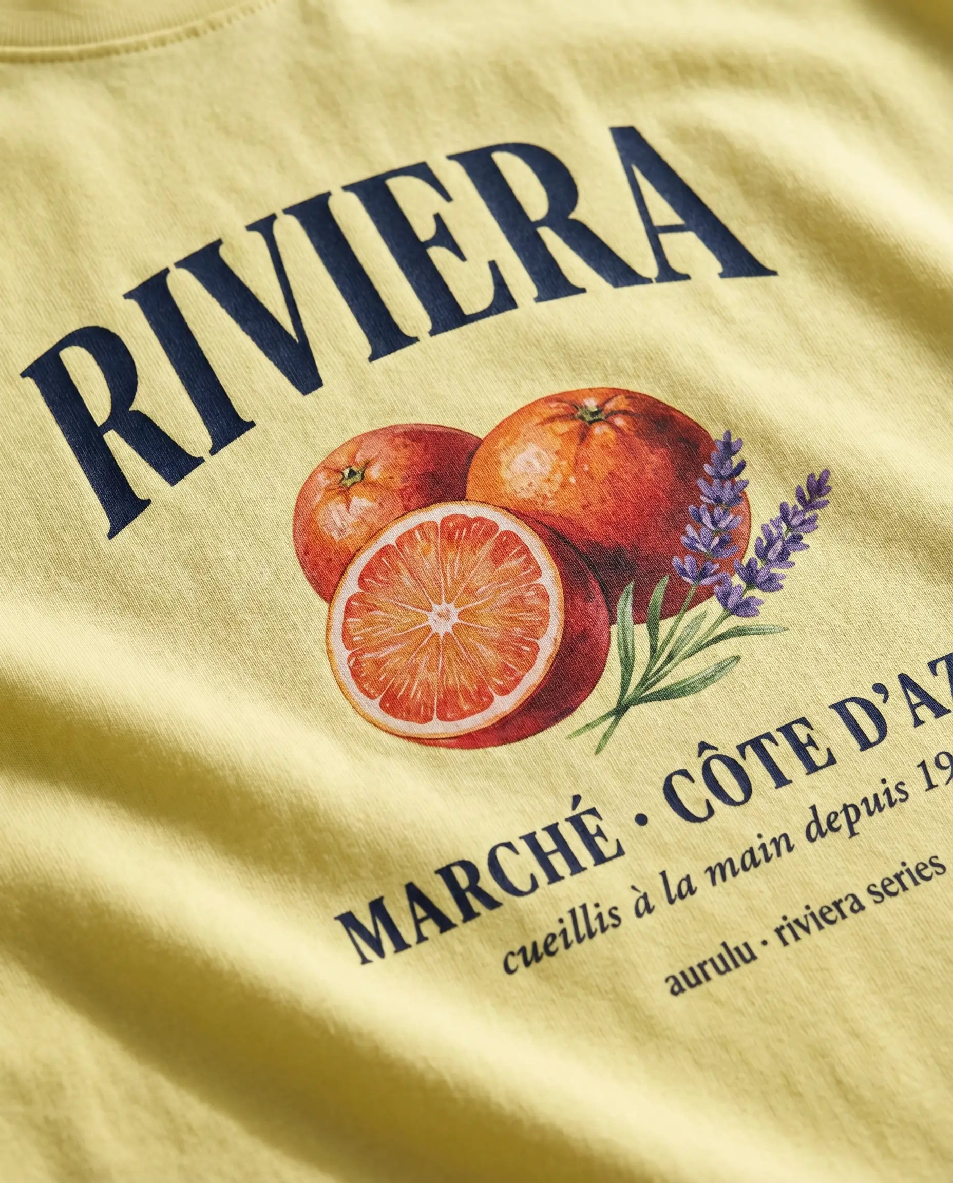 Print material oversized women's tee by aurulu featuring a Riviera Marché design, shown in a relaxed fit on a model.