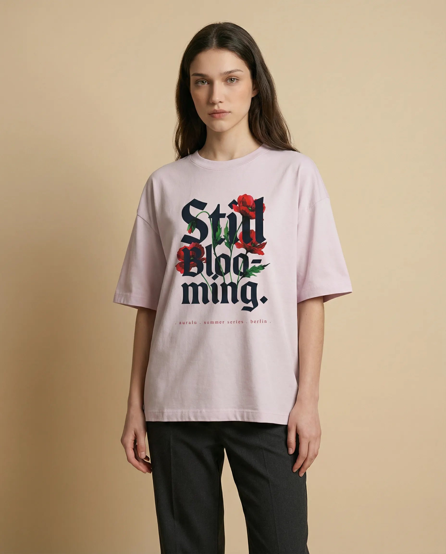 Still Blooming women's oversized tee with vibrant print by aurulu, showcasing a relaxed fit and colorful floral design.