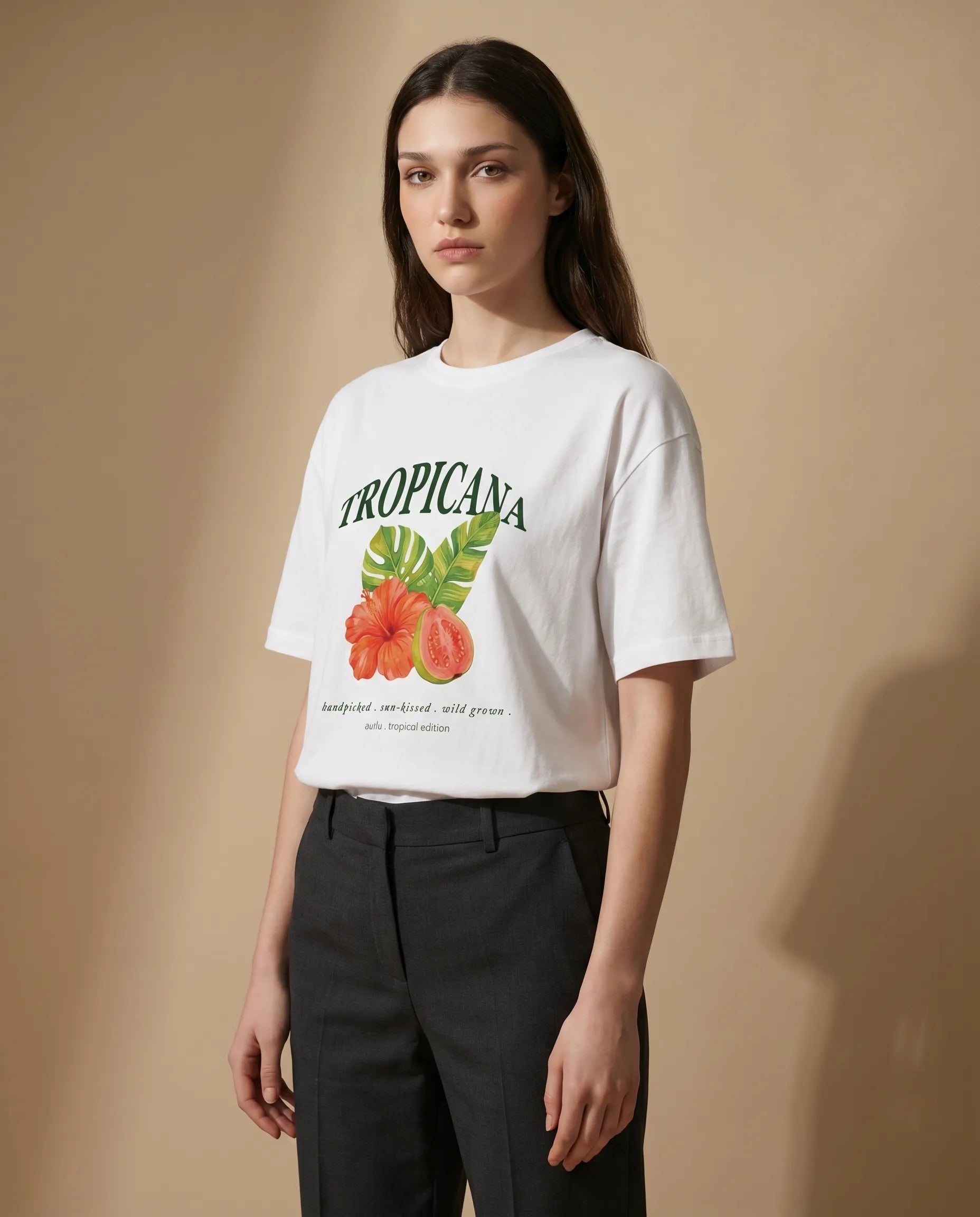 Tropicana Women's Tee by aurulu featuring vibrant tropical print on soft fabric, displayed on a white background.